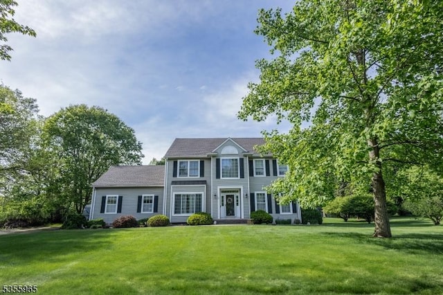 colonial-style house with a front yard