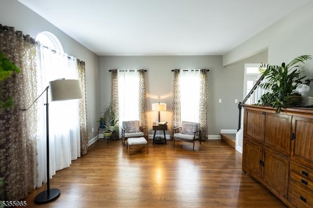 sitting room featuring wood finished floors, stairway, and baseboards