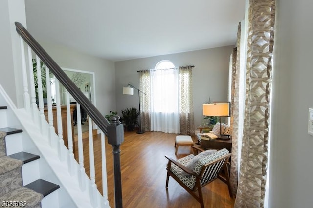stairs featuring wood finished floors