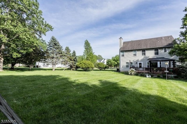 view of grassy yard with a gazebo and a deck