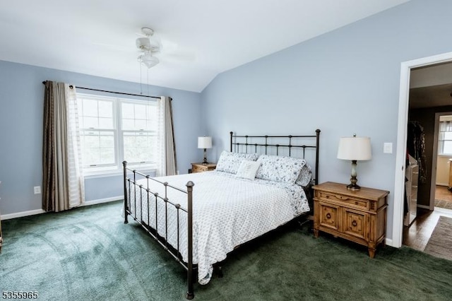 bedroom with carpet floors, lofted ceiling, baseboards, and ceiling fan