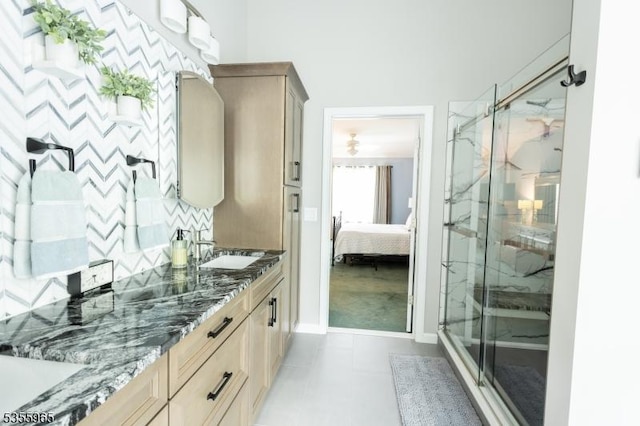 full bathroom featuring a marble finish shower, ensuite bathroom, vanity, and baseboards