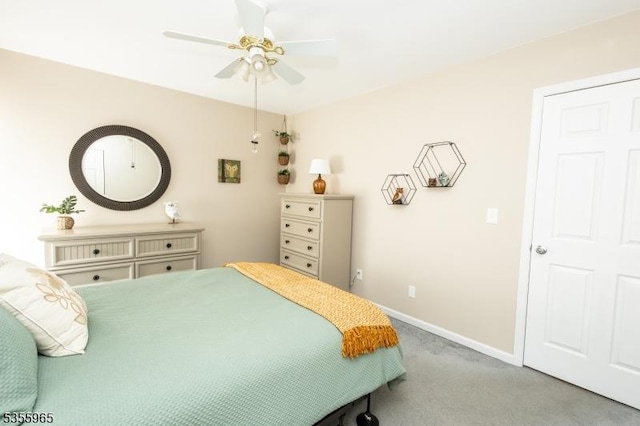 carpeted bedroom featuring baseboards and a ceiling fan