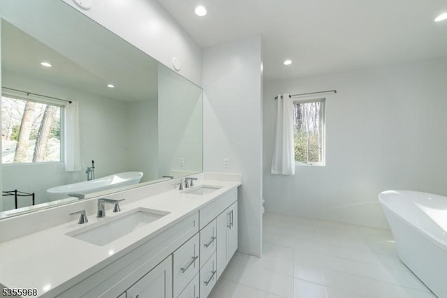 34 W Shore Rd, Mountain Lakes Boro, NJ 07046 - full bath with healthy amount of natural light, a soaking tub, double vanity, recessed lighting, and toilet