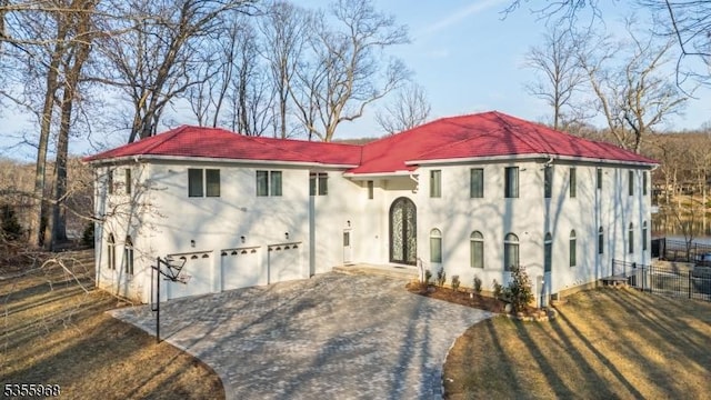 34 W Shore Rd, Mountain Lakes Boro, NJ 07046 - mediterranean / spanish home featuring stucco siding, driveway, fence, and an attached garage