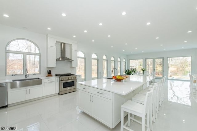 34 W Shore Rd, Mountain Lakes Boro, NJ 07046 - kitchen featuring wall chimney range hood, a sink, stainless steel appliances, recessed lighting, and backsplash