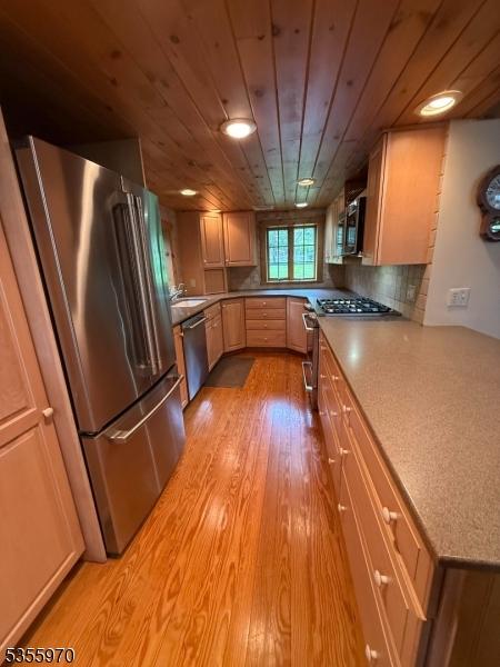 217 Bearfort Rd, West Milford Twp, NJ 07480 - kitchen featuring appliances with stainless steel finishes, wood ceiling, a sink, light brown cabinets, and backsplash