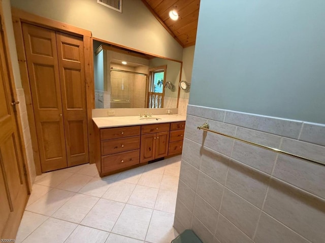 217 Bearfort Rd, West Milford Twp, NJ 07480 - full bathroom featuring tile walls, lofted ceiling, vanity, tile patterned flooring, and a shower stall