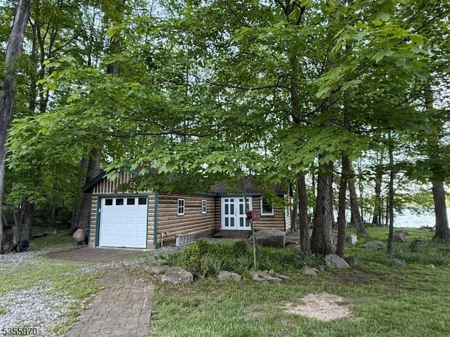217 Bearfort Rd, West Milford Twp, NJ 07480 - view of front facade with french doors, faux log siding, a garage, and driveway
