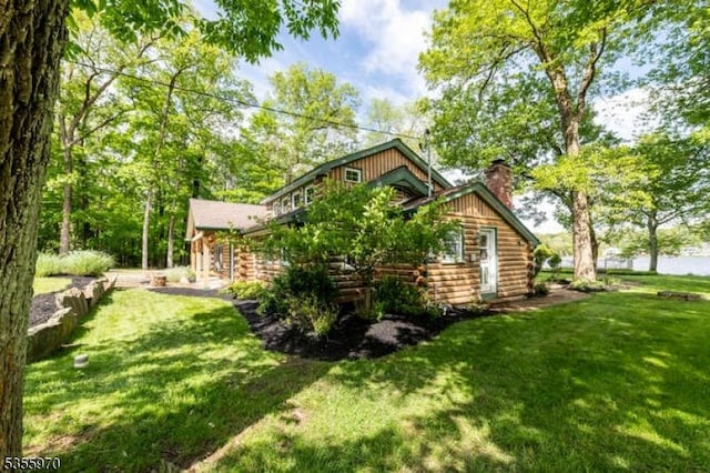 217 Bearfort Rd, West Milford Twp, NJ 07480 - view of side of property with log siding, a yard, and a chimney