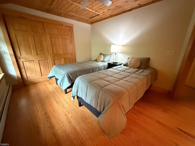 217 Bearfort Rd, West Milford Twp, NJ 07480 - bedroom with wooden ceiling, light wood-style floors, and a baseboard radiator