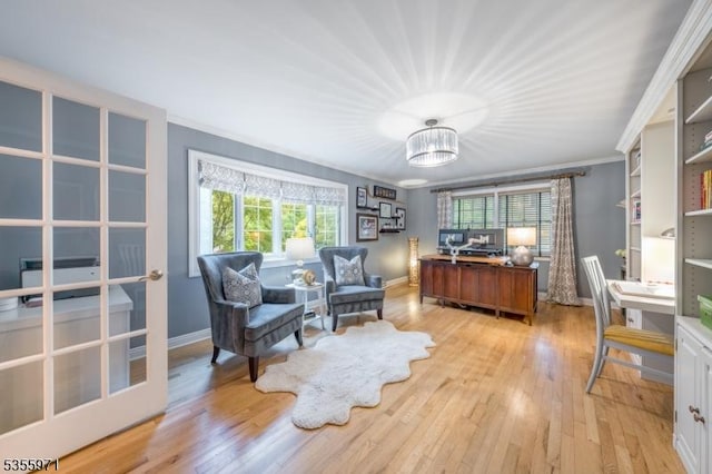 office space featuring light wood-style flooring, baseboards, and ornamental molding