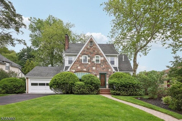 10 Highland Pl, West Orange Twp, NJ 07052 - english style home featuring asphalt driveway, stone siding, a front lawn, and a chimney