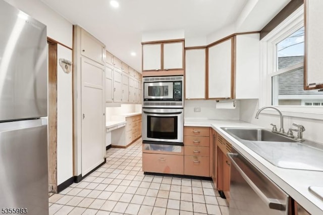 10 Highland Pl, West Orange Twp, NJ 07052 - kitchen featuring stainless steel appliances, light countertops, a sink, recessed lighting, and light tile patterned flooring