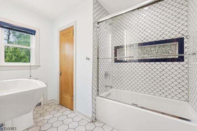 10 Highland Pl, West Orange Twp, NJ 07052 - bathroom featuring bath / shower combo with glass door, tile patterned flooring, and baseboards