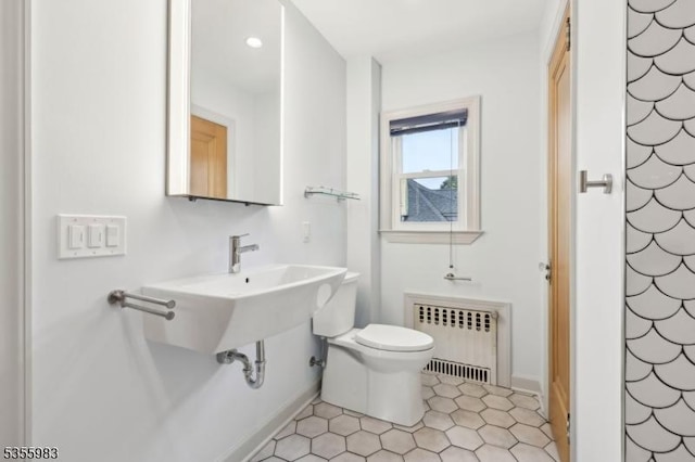 10 Highland Pl, West Orange Twp, NJ 07052 - bathroom featuring radiator, toilet, baseboards, and tile patterned floors