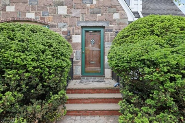10 Highland Pl, West Orange Twp, NJ 07052 - view of exterior entry featuring roof with shingles