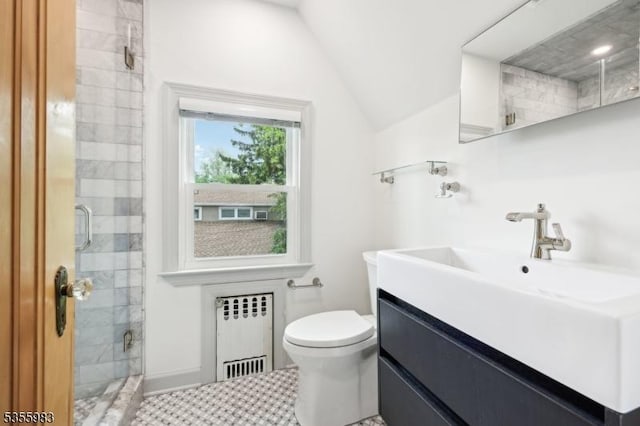 10 Highland Pl, West Orange Twp, NJ 07052 - bathroom featuring radiator heating unit, vanity, a stall shower, lofted ceiling, and toilet