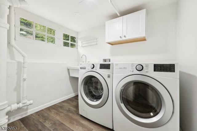 10 Highland Pl, West Orange Twp, NJ 07052 - laundry room featuring washer and dryer, cabinet space, wood finished floors, and baseboards