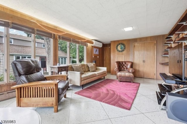 10 Highland Pl, West Orange Twp, NJ 07052 - living room featuring dark aggregate flooring, an AC wall unit, wooden walls, and plenty of natural light