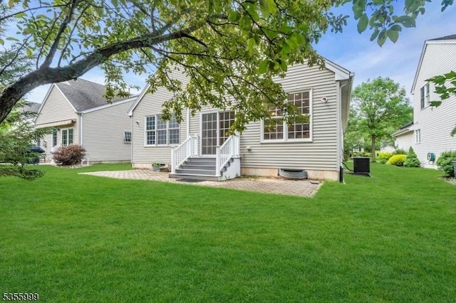 27 Jays Cor, Franklin Twp, NJ 08873 - rear view of house featuring a lawn and a patio area