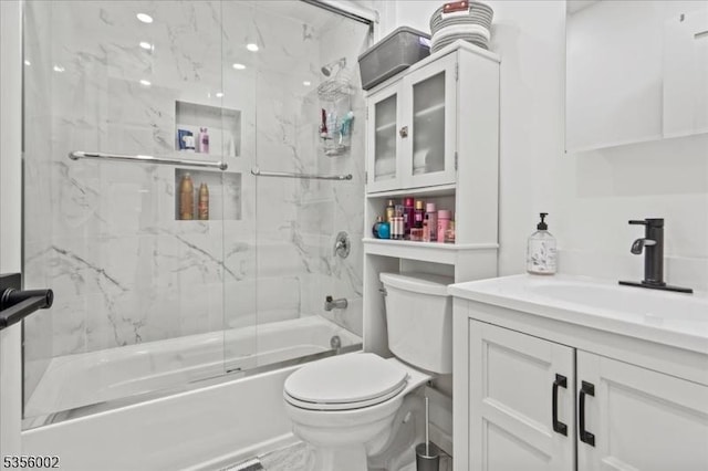 full bathroom featuring toilet, vanity, and enclosed tub / shower combo