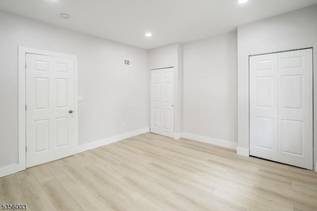 unfurnished bedroom featuring recessed lighting, light wood finished floors, and baseboards