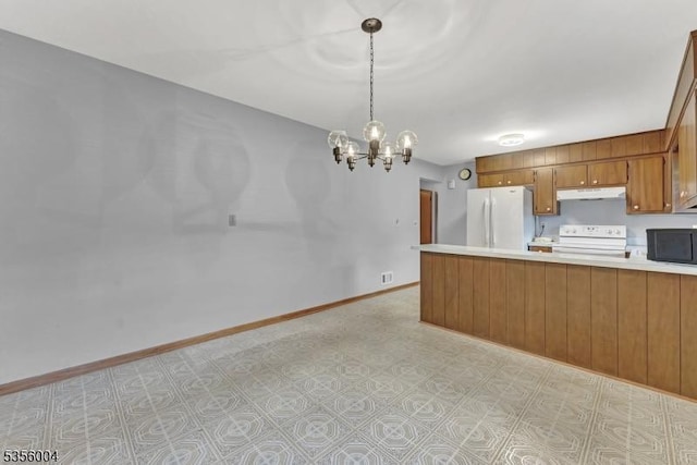 45 Ninth St, Hillsborough Twp, NJ 08821 - kitchen featuring white appliances, under cabinet range hood, brown cabinetry, light countertops, and a chandelier