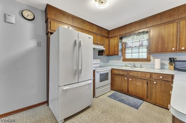 45 Ninth St, Hillsborough Twp, NJ 08821 - kitchen featuring white appliances, under cabinet range hood, light countertops, and brown cabinetry