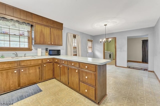 45 Ninth St, Hillsborough Twp, NJ 08821 - kitchen featuring black microwave, light countertops, a peninsula, brown cabinetry, and a chandelier