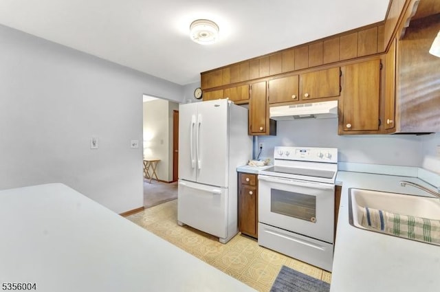 45 Ninth St, Hillsborough Twp, NJ 08821 - kitchen with white appliances, under cabinet range hood, brown cabinets, light countertops, and light floors
