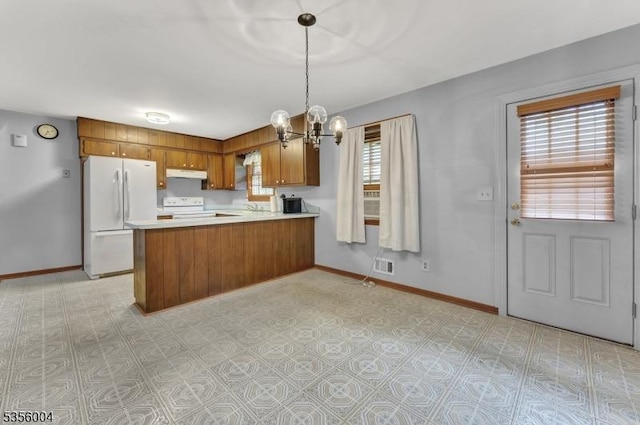 45 Ninth St, Hillsborough Twp, NJ 08821 - kitchen with white appliances, brown cabinets, a chandelier, under cabinet range hood, and light countertops