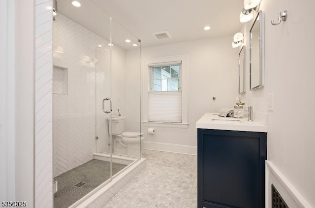 bathroom featuring vanity, recessed lighting, a shower stall, baseboards, and toilet