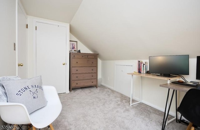 office space featuring light carpet and lofted ceiling