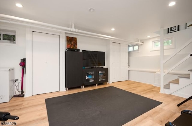 exercise area with wood finished floors and recessed lighting