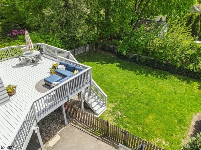 view of yard with a wooden deck, stairway, and an outdoor hangout area