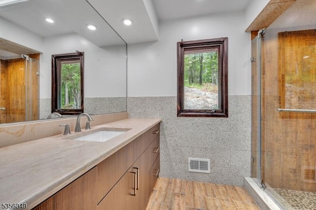 142 Decker Rd, Rockaway Twp, NJ 07005 - bathroom featuring vanity, tile walls, a stall shower, wainscoting, and recessed lighting