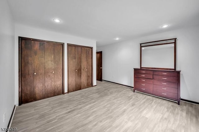 142 Decker Rd, Rockaway Twp, NJ 07005 - unfurnished bedroom featuring light wood-style flooring, two closets, and recessed lighting