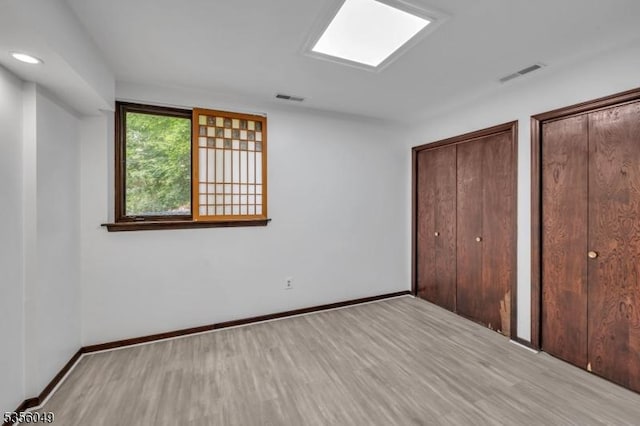 142 Decker Rd, Rockaway Twp, NJ 07005 - unfurnished bedroom featuring light wood-type flooring and multiple closets