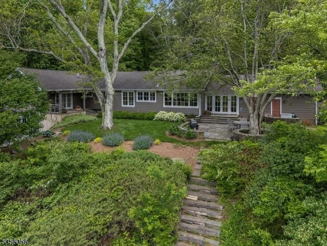 12 Woodland Rd, Franklin Twp, NJ 08867 - view of front of property featuring french doors, a patio, and a front lawn