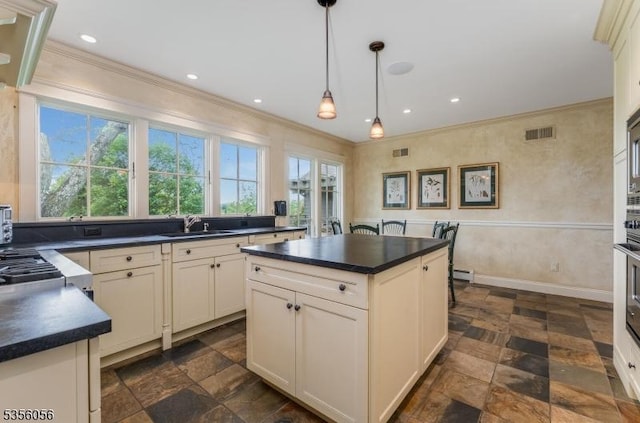 12 Woodland Rd, Franklin Twp, NJ 08867 - kitchen with dark countertops, a sink, ornamental molding, dark stone finish floors, and decorative light fixtures