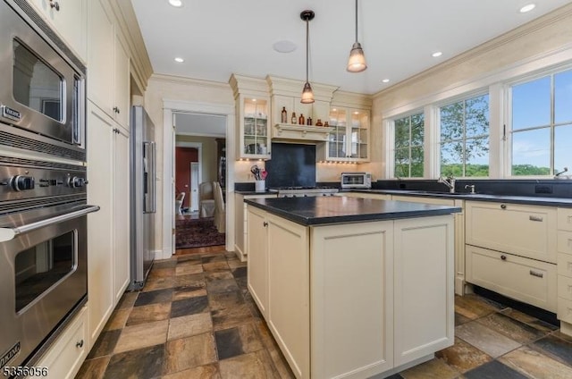 12 Woodland Rd, Franklin Twp, NJ 08867 - kitchen with stainless steel appliances, dark countertops, dark stone finish floors, glass insert cabinets, and ornamental molding