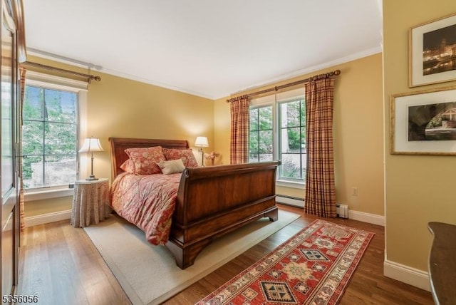 12 Woodland Rd, Franklin Twp, NJ 08867 - bedroom featuring crown molding, wood finished floors, baseboards, a baseboard heating unit, and a baseboard radiator
