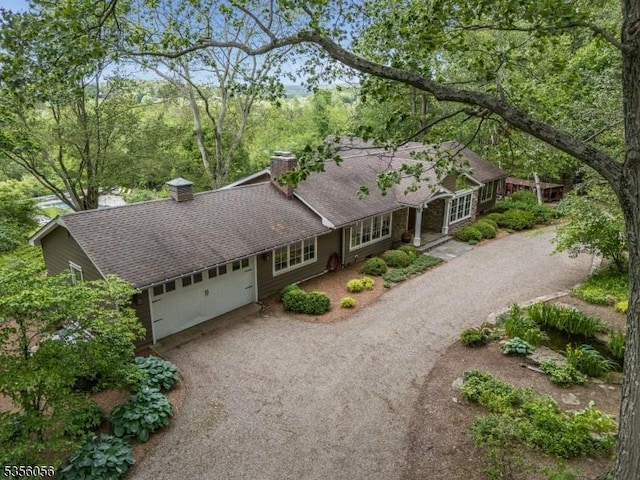 12 Woodland Rd, Franklin Twp, NJ 08867 - ranch-style home with a chimney, dirt driveway, a garage, and a shingled roof