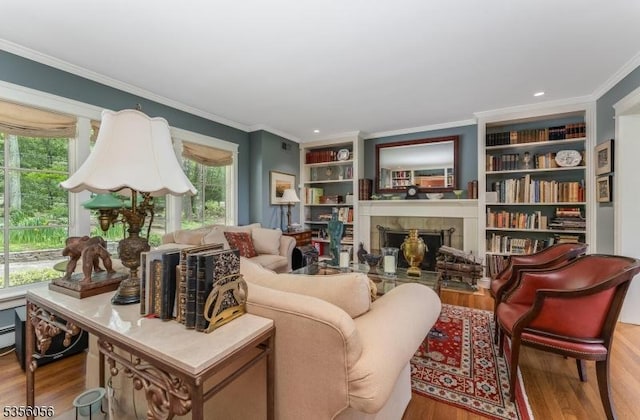 12 Woodland Rd, Franklin Twp, NJ 08867 - living area featuring wood finished floors, healthy amount of natural light, crown molding, a tile fireplace, and built in shelves