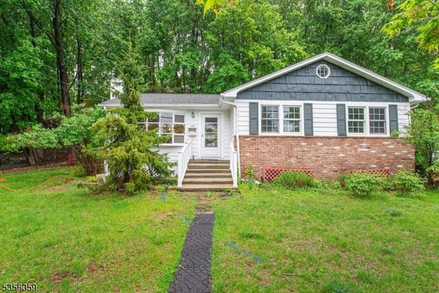 view of front of house featuring a front yard and brick siding