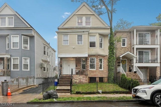 townhome / multi-family property with a fenced front yard