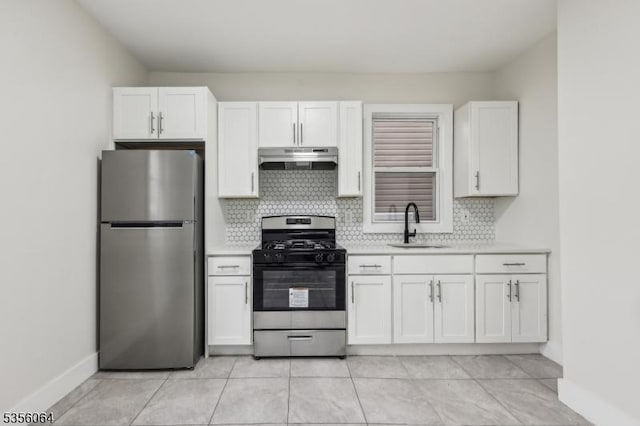kitchen featuring stainless steel appliances, under cabinet range hood, a sink, light countertops, and tasteful backsplash