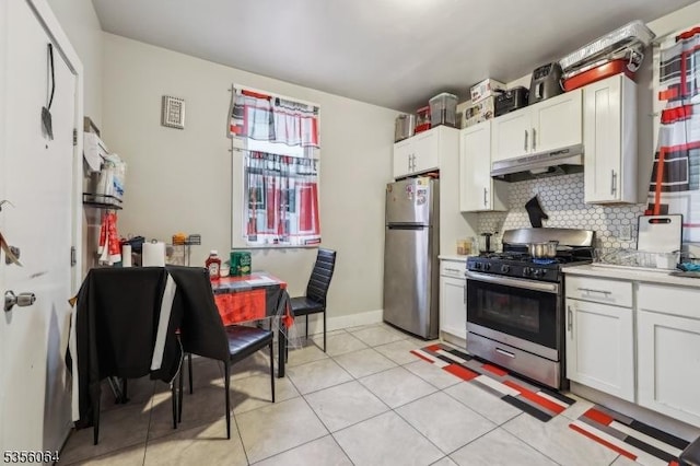kitchen featuring stainless steel appliances, under cabinet range hood, backsplash, light countertops, and white cabinets