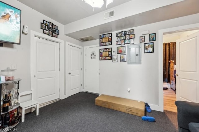 interior space with dark colored carpet and electric panel